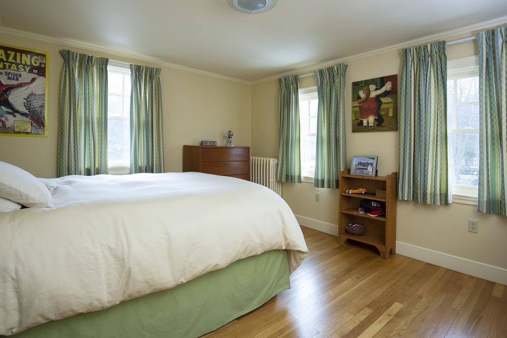 7 Locust Road Weston, MA 02493 - Photo 8 of 13 a bedroom with a bed and wooden floor