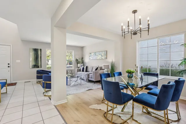 a living room with furniture and a chandelier