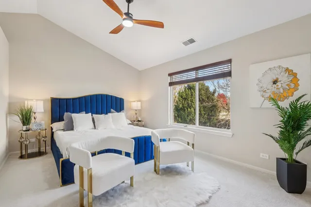 a bedroom with a bed and a potted plant