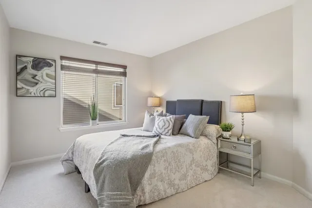 a bedroom with a bed and lamp