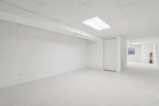 a view of backyard of house with green space