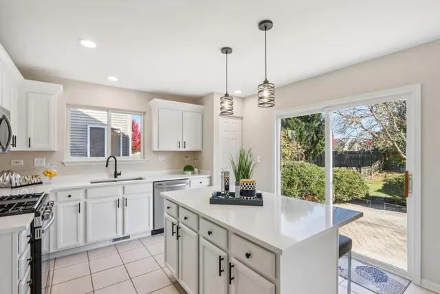 a kitchen with a sink stove and cabinets