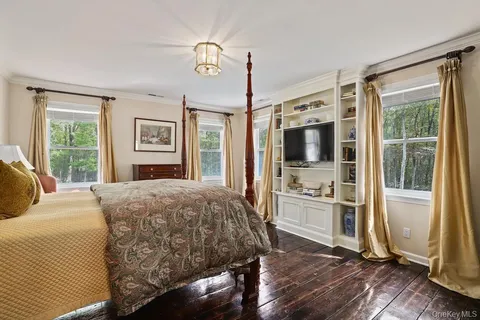 a spacious bedroom with a large bed and a dresser