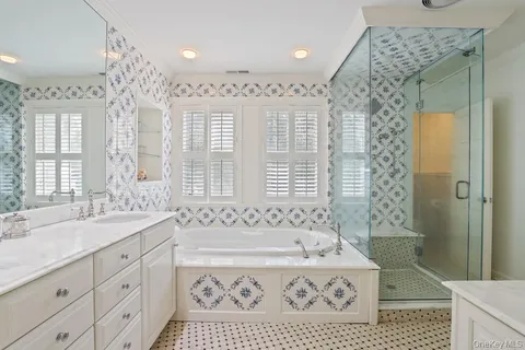 a spacious bathroom with sink shower and a bathtub