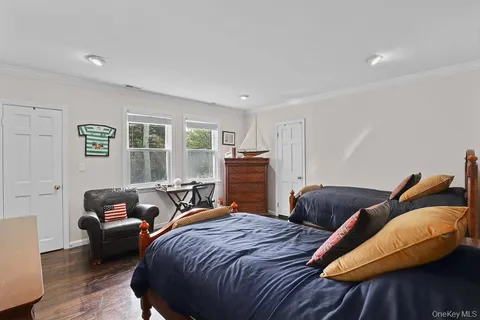 a bedroom with two beds and a couch