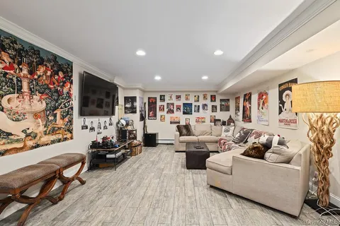 a living room with fireplace furniture and a flat screen tv