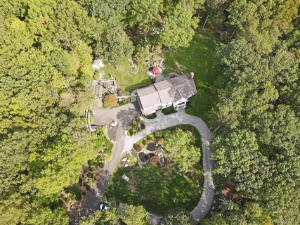 view of a house with a yard and garden
