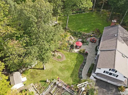 an aerial view of a residential houses with outdoor space