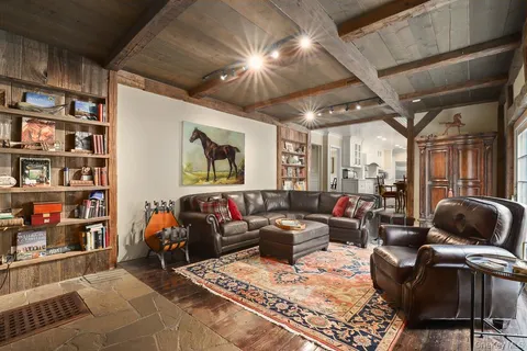 a living room with furniture and a book shelf