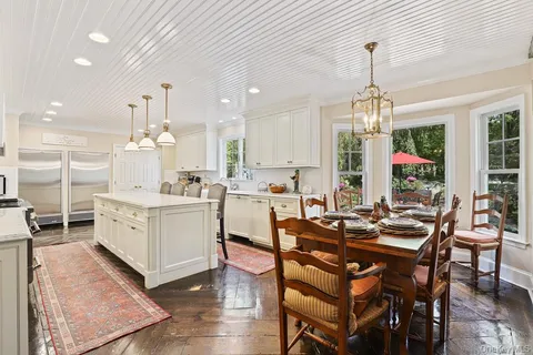 a kitchen with a table chairs stove and cabinets