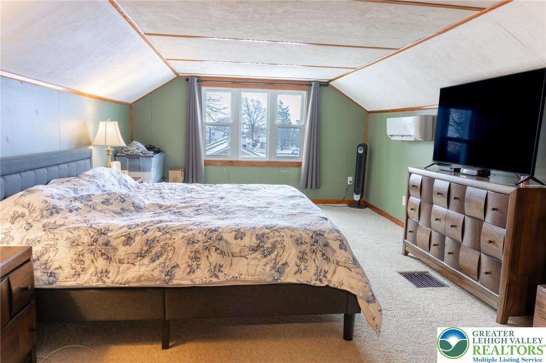 664 Locke Heights Road Bangor, PA 18013 - Photo 13 of 20 a bedroom with a bed and a flat tv screen on dresser