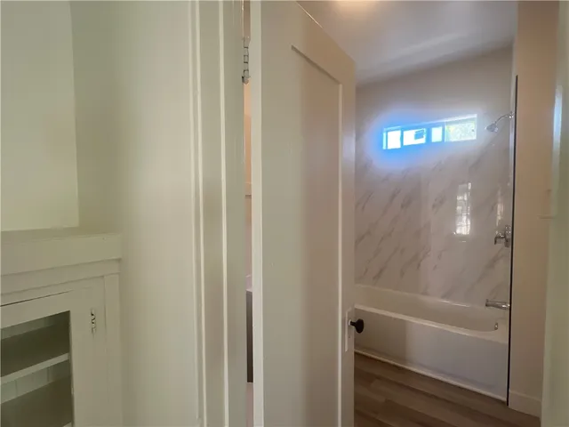 a kitchen with granite countertop wooden cabinets a sink and dishwasher with wooden floor