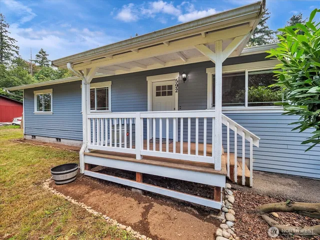 a view of a house with a wooden deck