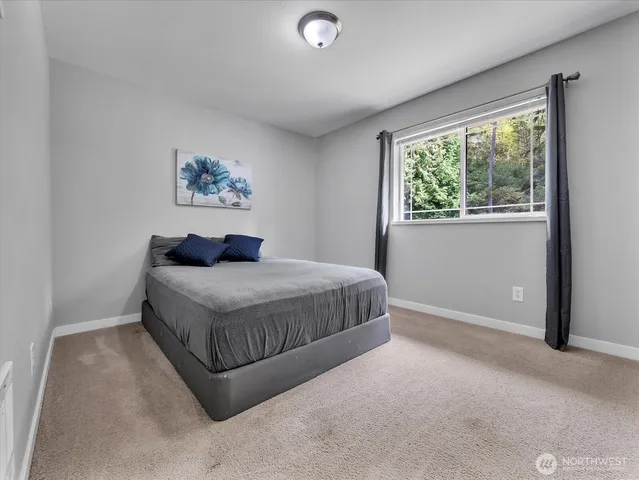 a bathroom with a granite countertop toilet sink and mirror