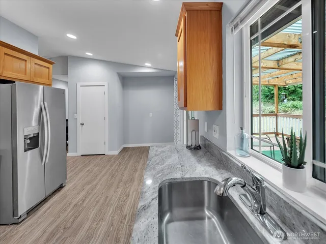 a kitchen with a refrigerator and a sink