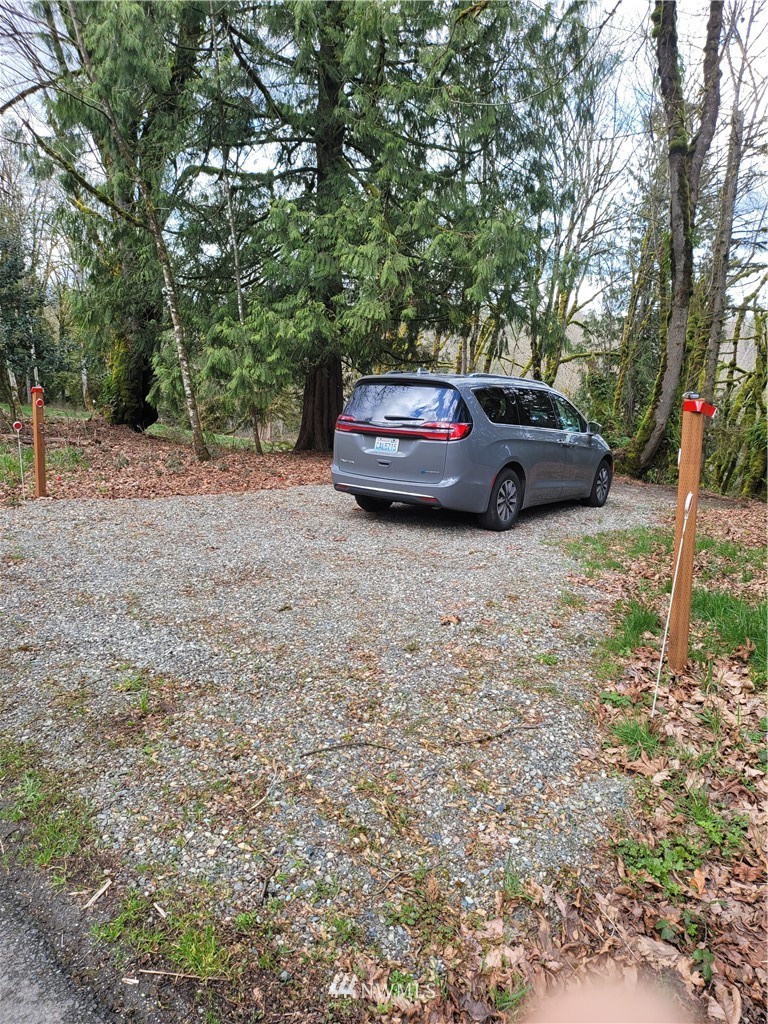 20109 Southeast Petrovitsky Road Maple Valley, WA 98038 - Photo 13 of 24 a car parked in front of a white house