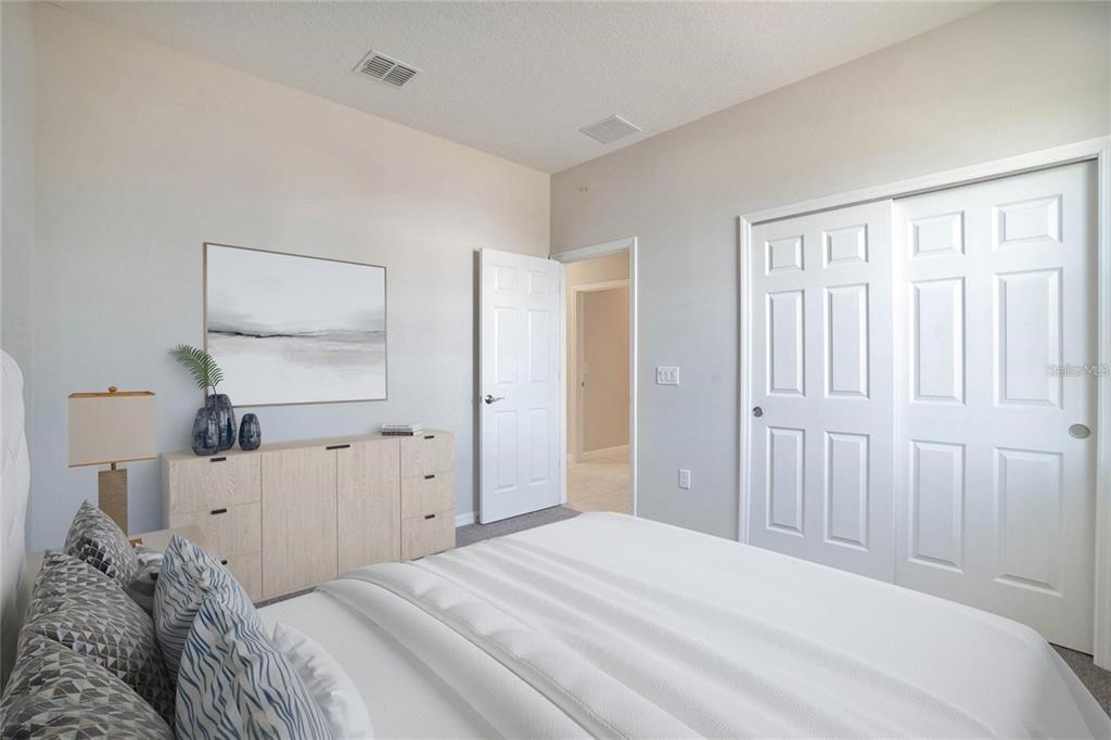 715 Poller Way Cocoa, FL 32927 - Photo 12 of 19 a bedroom with a bed and a lamp