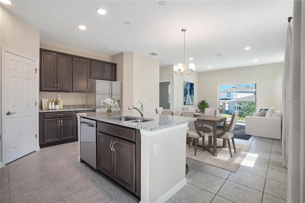 715 Poller Way Cocoa, FL 32927 - Photo 2 of 19 a kitchen with kitchen island granite countertop a sink counter top space appliances and cabinets