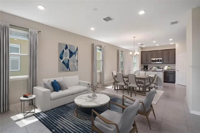 a living room with furniture and kitchen view