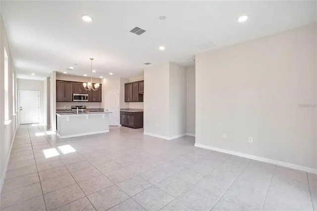 a view of a kitchen with a sink and a refrigerator