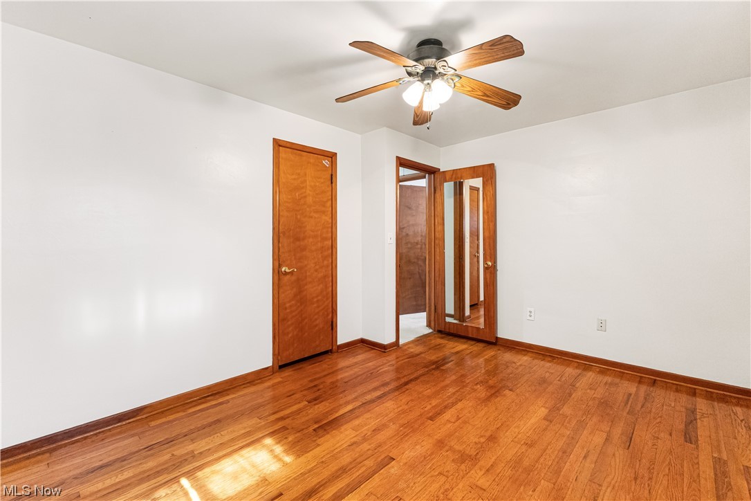 319 Glenview Road Canfield, OH 44406 - Photo 15 of 31 Spare room featuring ceiling fan and wood-type flooring