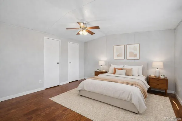 a bedroom with a bed and wooden floor