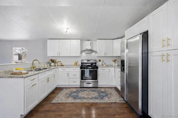 a kitchen with a stove top oven and refrigerator