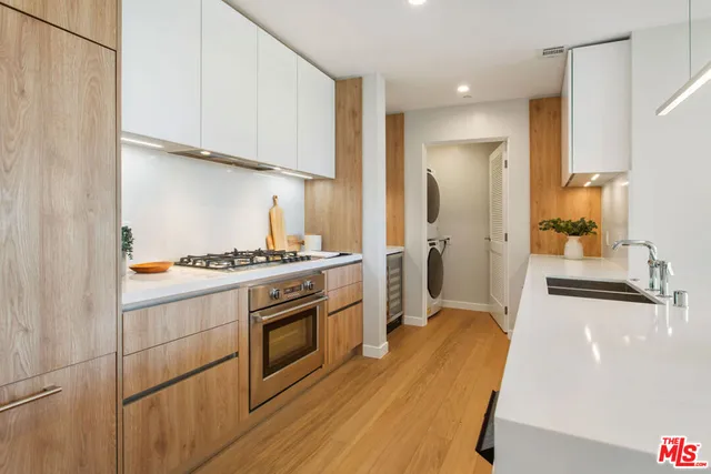 a kitchen with wooden floor and white appliances