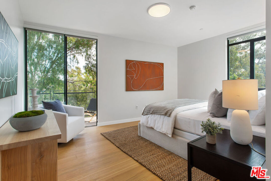 11600 Dunstan Way, Unit 404 Los Angeles, CA 90049 - Photo 14 of 28 a living room with furniture and a large window