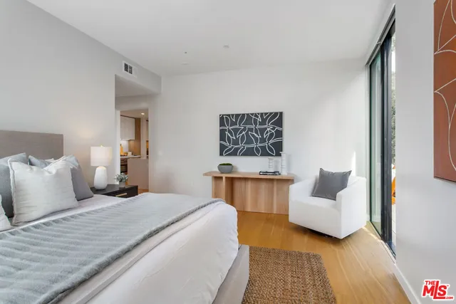 a bedroom with a bed and a couch