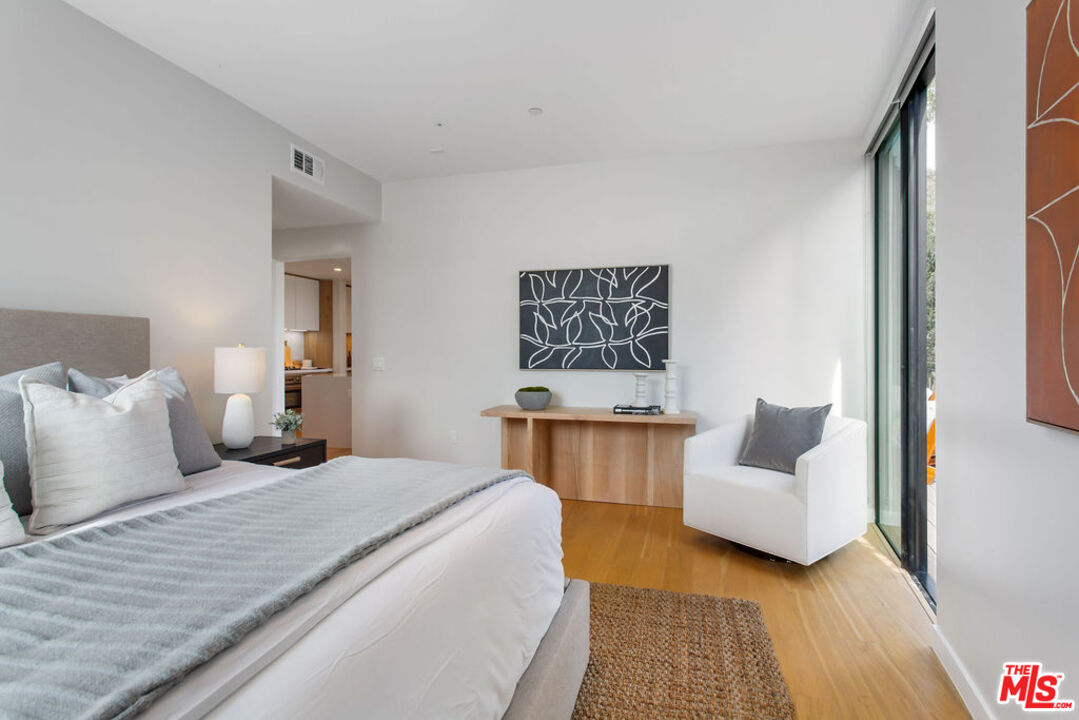 11600 Dunstan Way, Unit 404 Los Angeles, CA 90049 - Photo 15 of 28 a bedroom with a bed and a couch