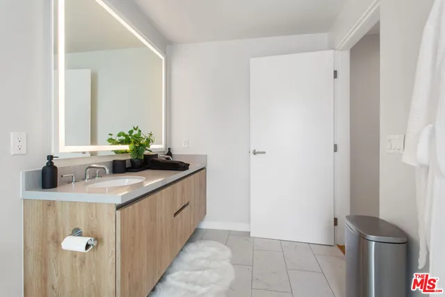 a kitchen with stainless steel appliances granite countertop a sink and a refrigerator