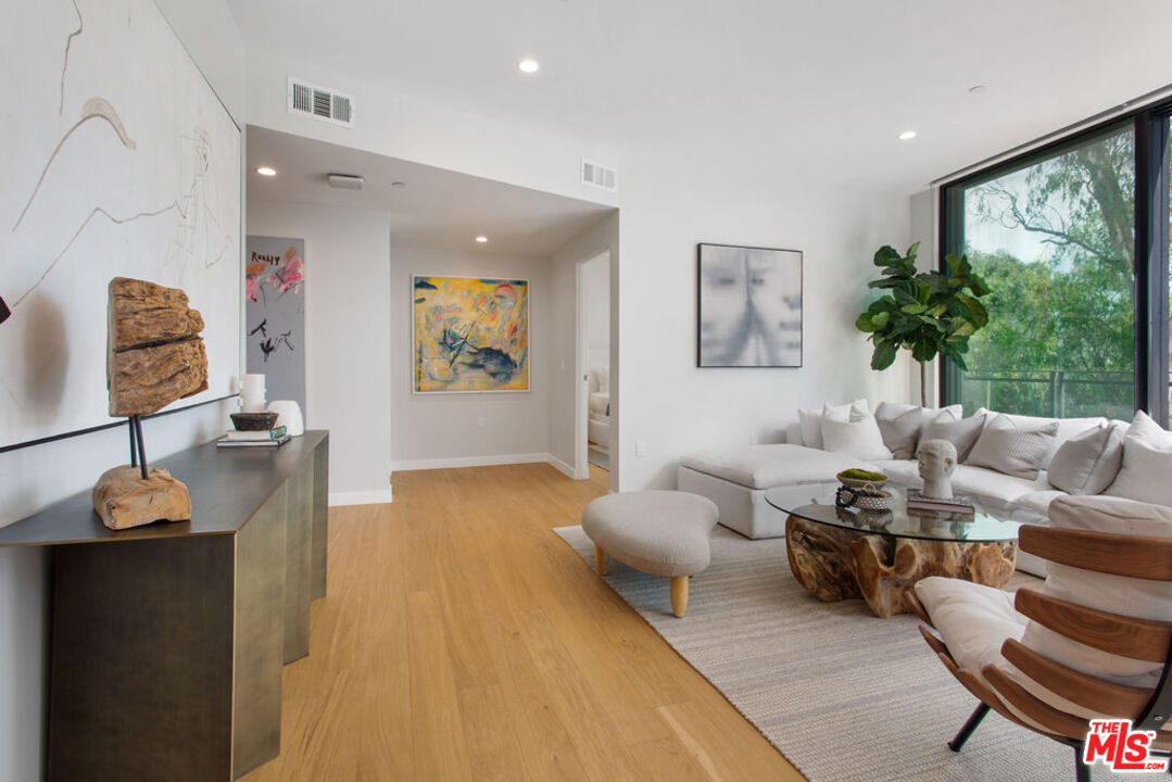 11600 Dunstan Way, Unit 404 Los Angeles, CA 90049 - Photo 21 of 28 a living room with furniture and a window