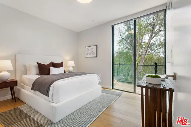 a bedroom with a bed and a large window