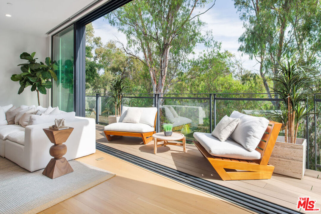 11600 Dunstan Way, Unit 404 Los Angeles, CA 90049 - Photo 4 of 28 a outdoor living space with furniture and a potted plant