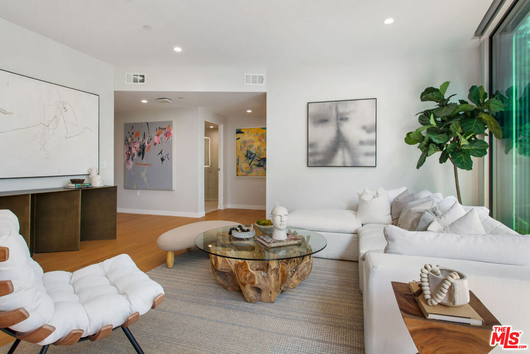 11600 Dunstan Way, Unit 404 Los Angeles, CA 90049 - Photo 7 of 28 a living room with furniture and a potted plant