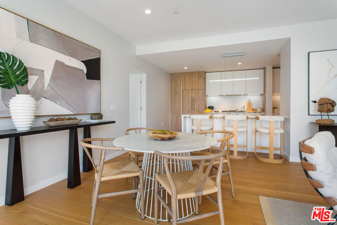 11600 Dunstan Way, Unit 404 Los Angeles, CA 90049 - Photo 8 of 28 a view of a dining room with furniture and a table