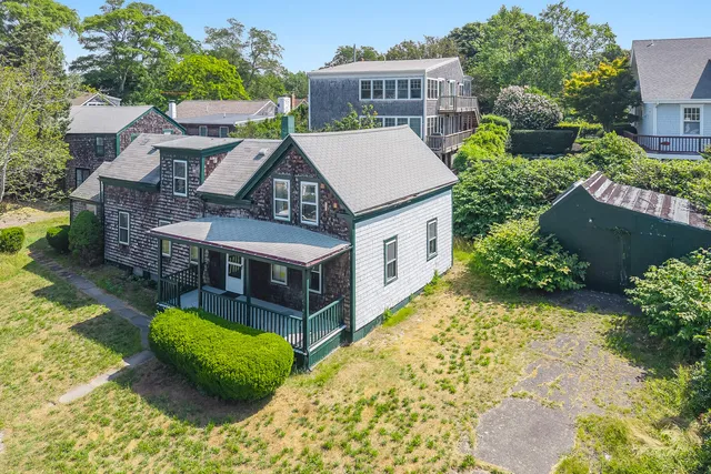 an aerial view of a house with a yard table and chairs