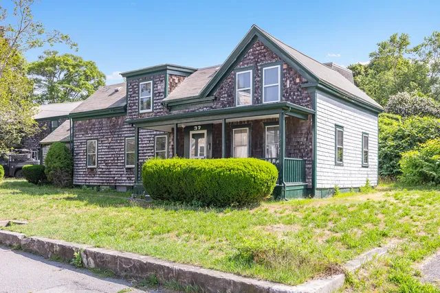 a front view of house with yard and green space