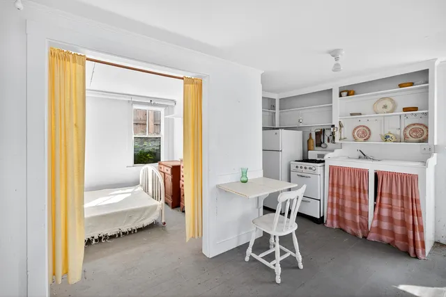a dining room with furniture and a window