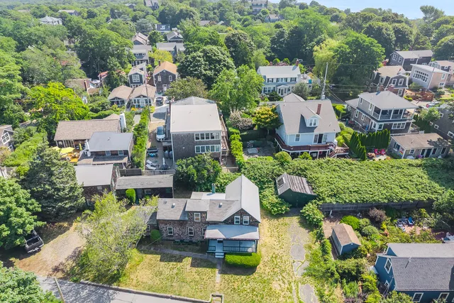 an aerial view of a house with a garden and lake view