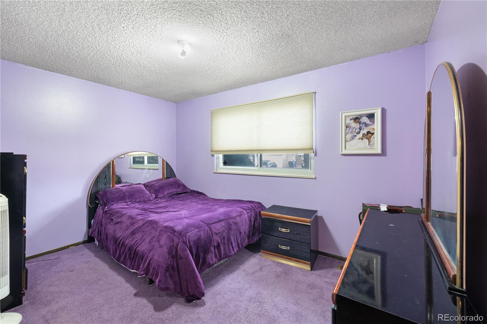 5311 Troy Street Denver, CO 80239 - Photo 15 of 46 a bedroom with a bed and wooden floor