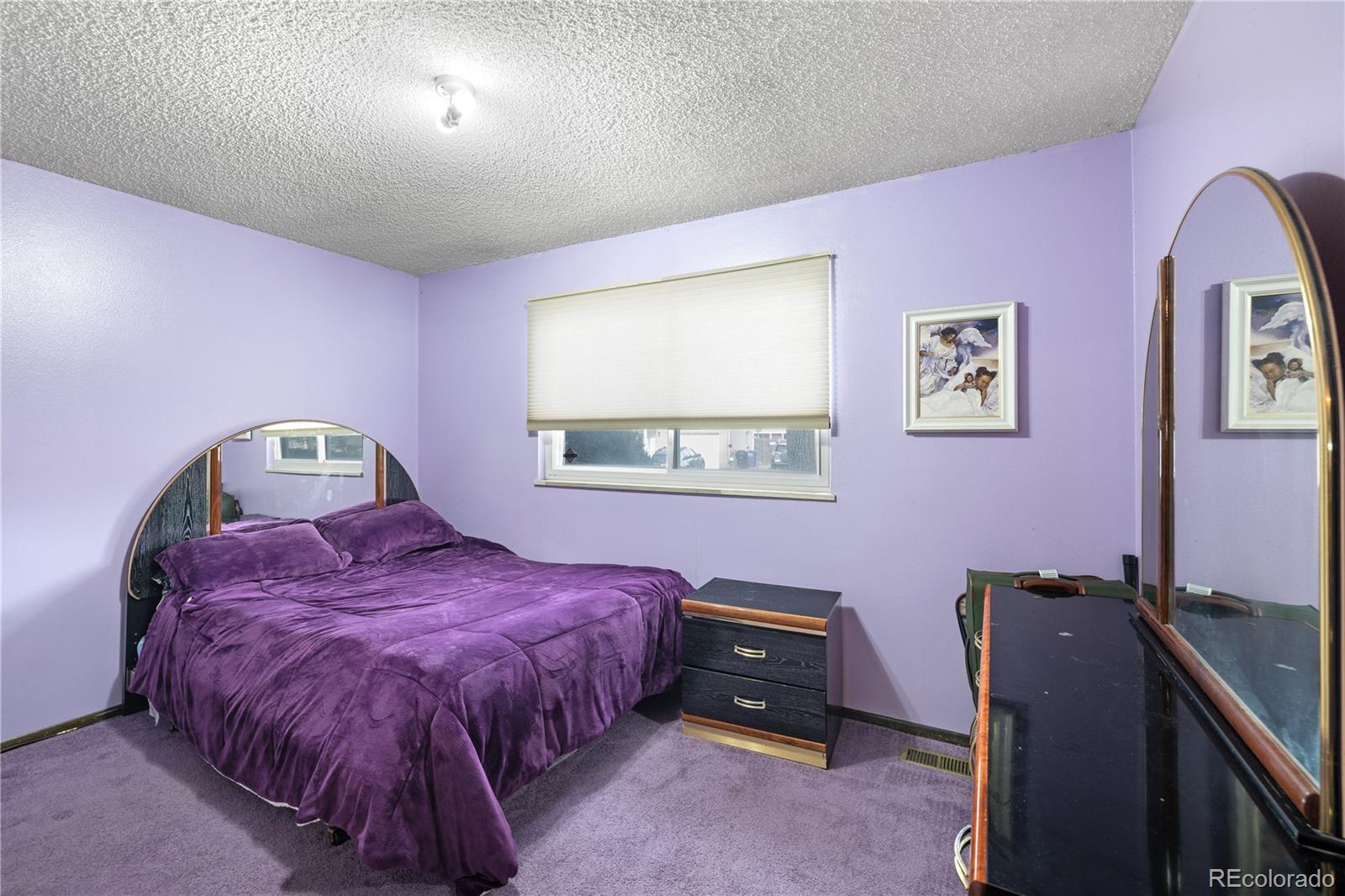 5311 Troy Street Denver, CO 80239 - Photo 17 of 46 a bedroom with a bed and a workspace