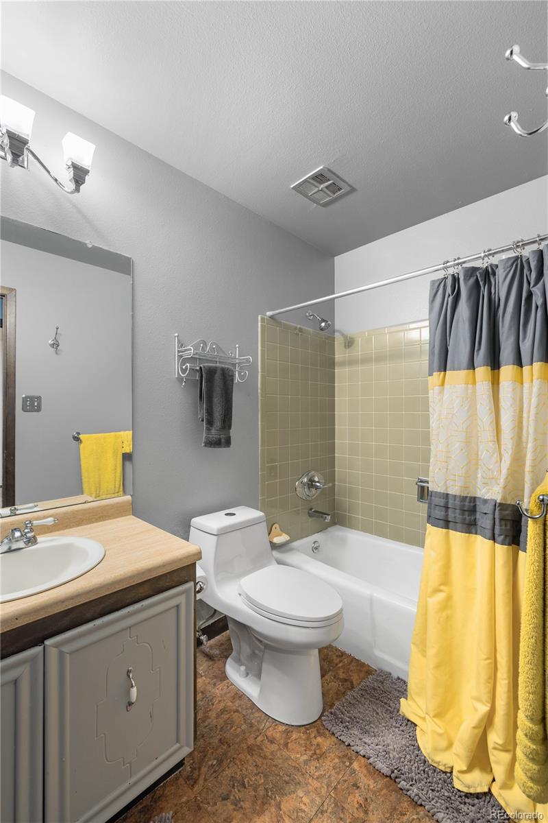 5311 Troy Street Denver, CO 80239 - Photo 19 of 46 a bathroom with a sink and a mirror
