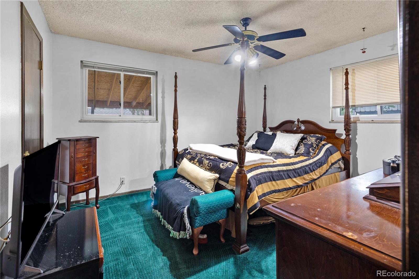 5311 Troy Street Denver, CO 80239 - Photo 23 of 46 a bedroom with furniture and a window