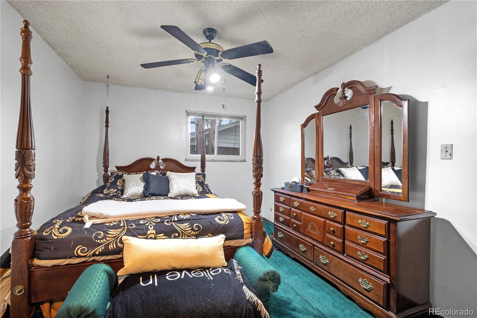 5311 Troy Street Denver, CO 80239 - Photo 24 of 46 a bedroom with a bed and a dresser in it