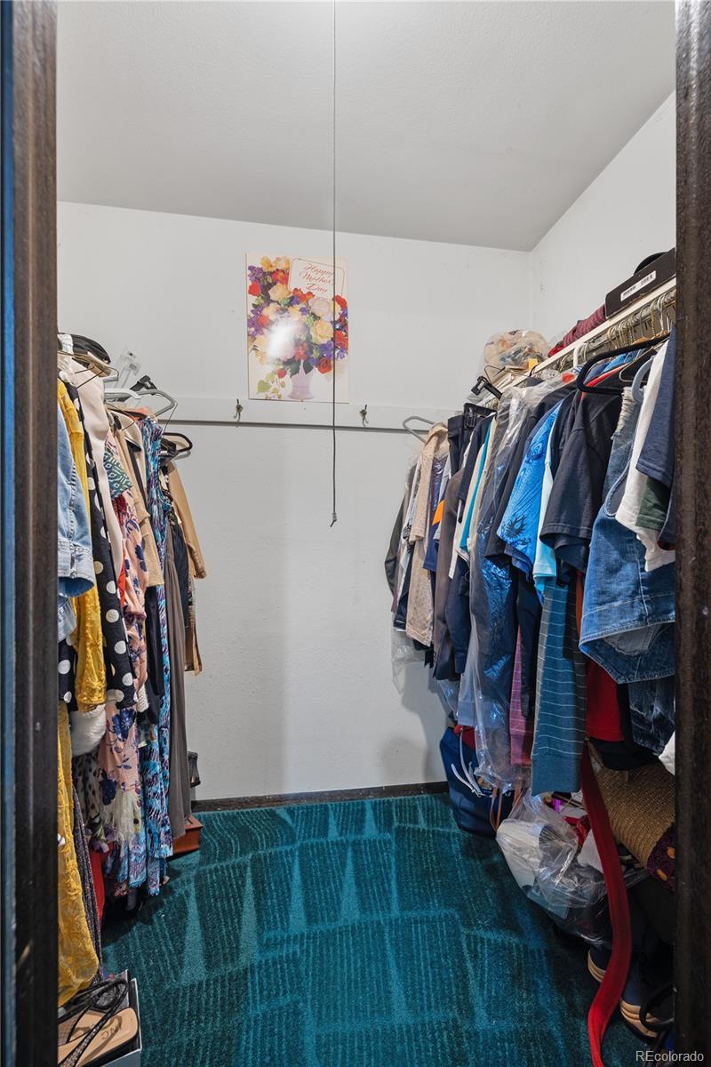 5311 Troy Street Denver, CO 80239 - Photo 25 of 46 a view of walk in closet with clothes