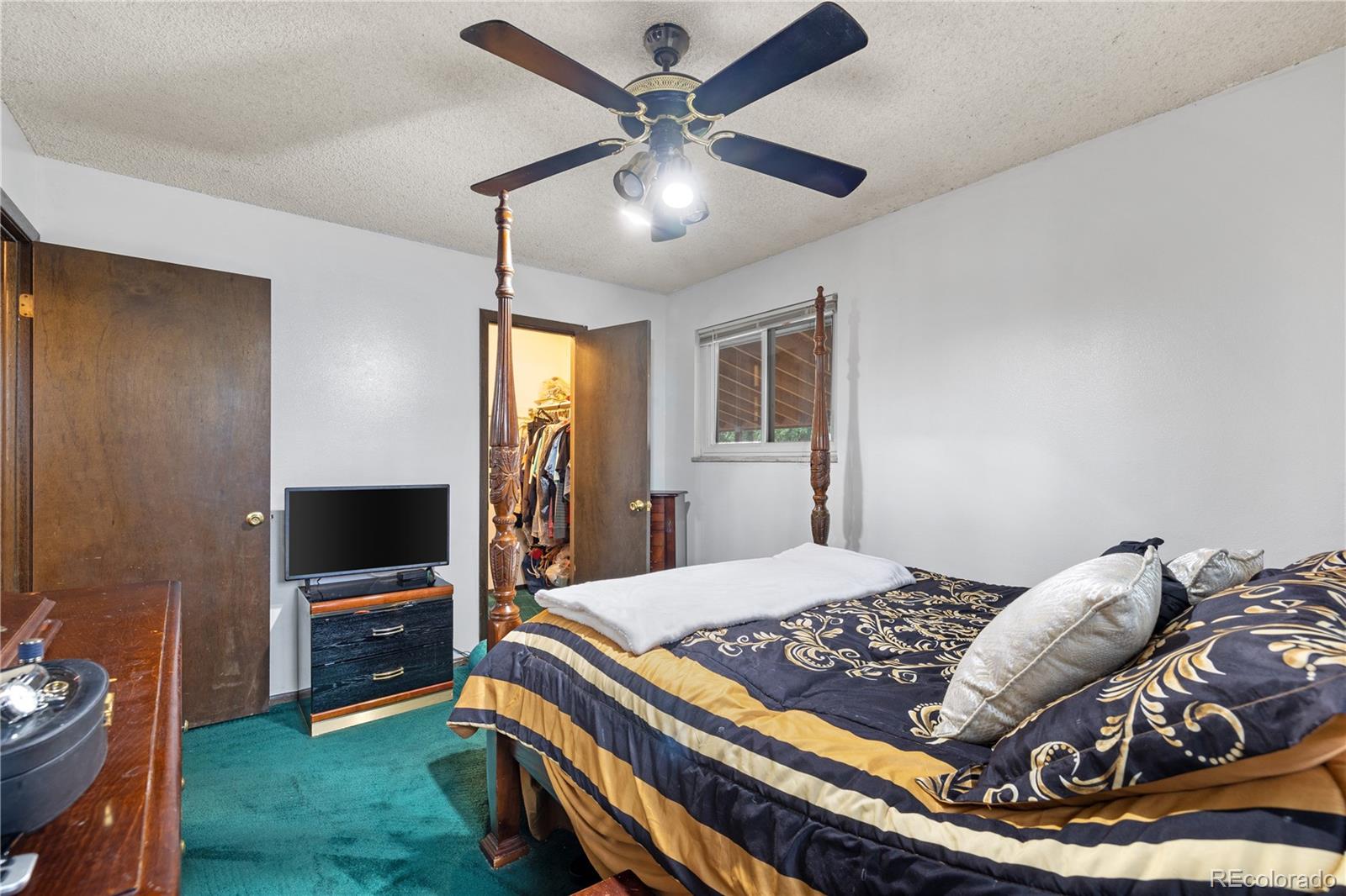 5311 Troy Street Denver, CO 80239 - Photo 26 of 46 a bedroom with a bed and a tv