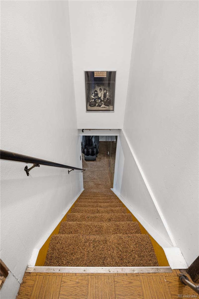 5311 Troy Street Denver, CO 80239 - Photo 27 of 46 a view of a hallway with wooden floor