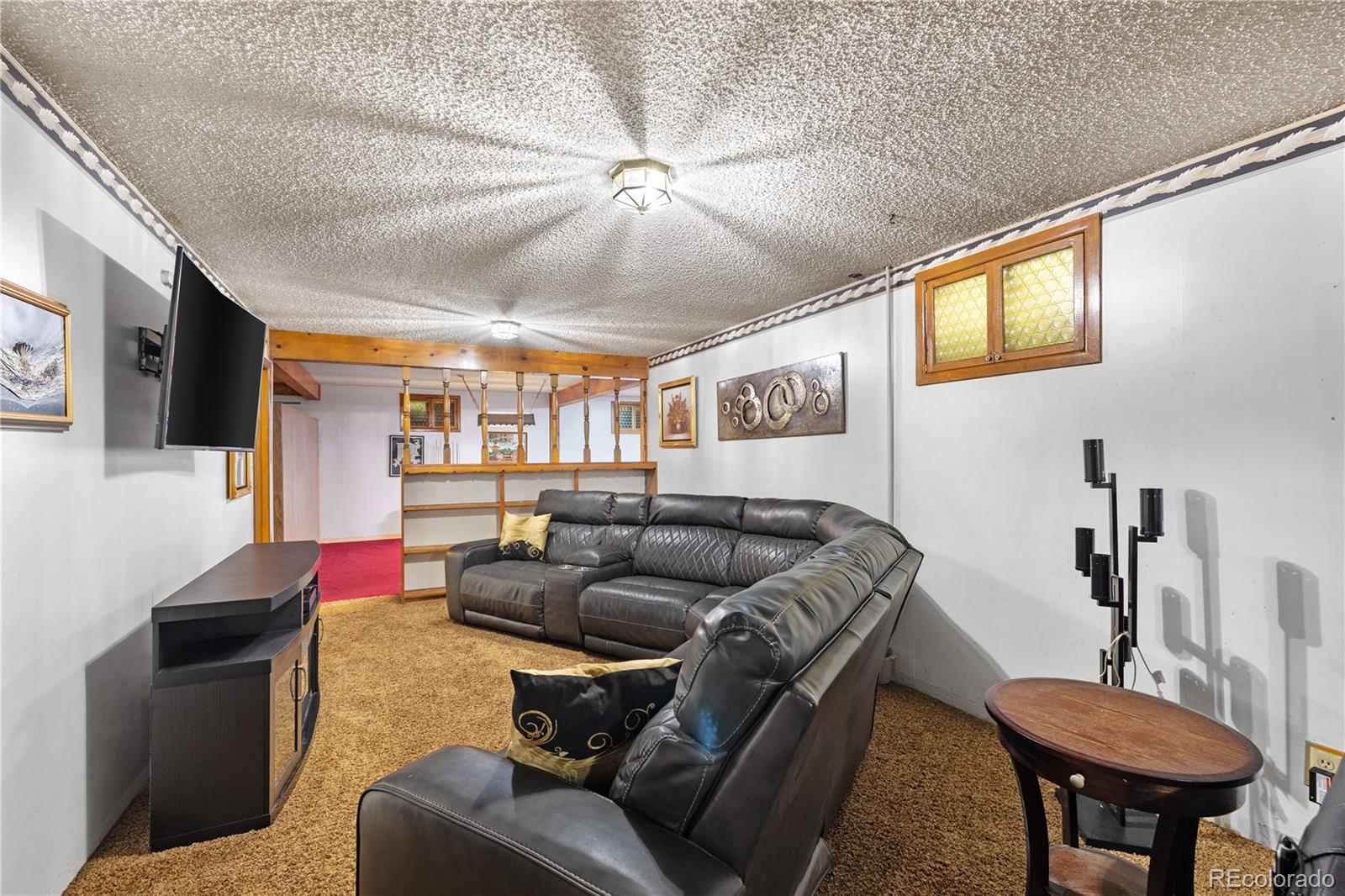 5311 Troy Street Denver, CO 80239 - Photo 31 of 46 a living room with furniture and a flat screen tv